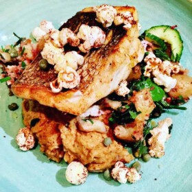 Roasted sea bass, curried cauliflower puree with tikka crushed new potatoes